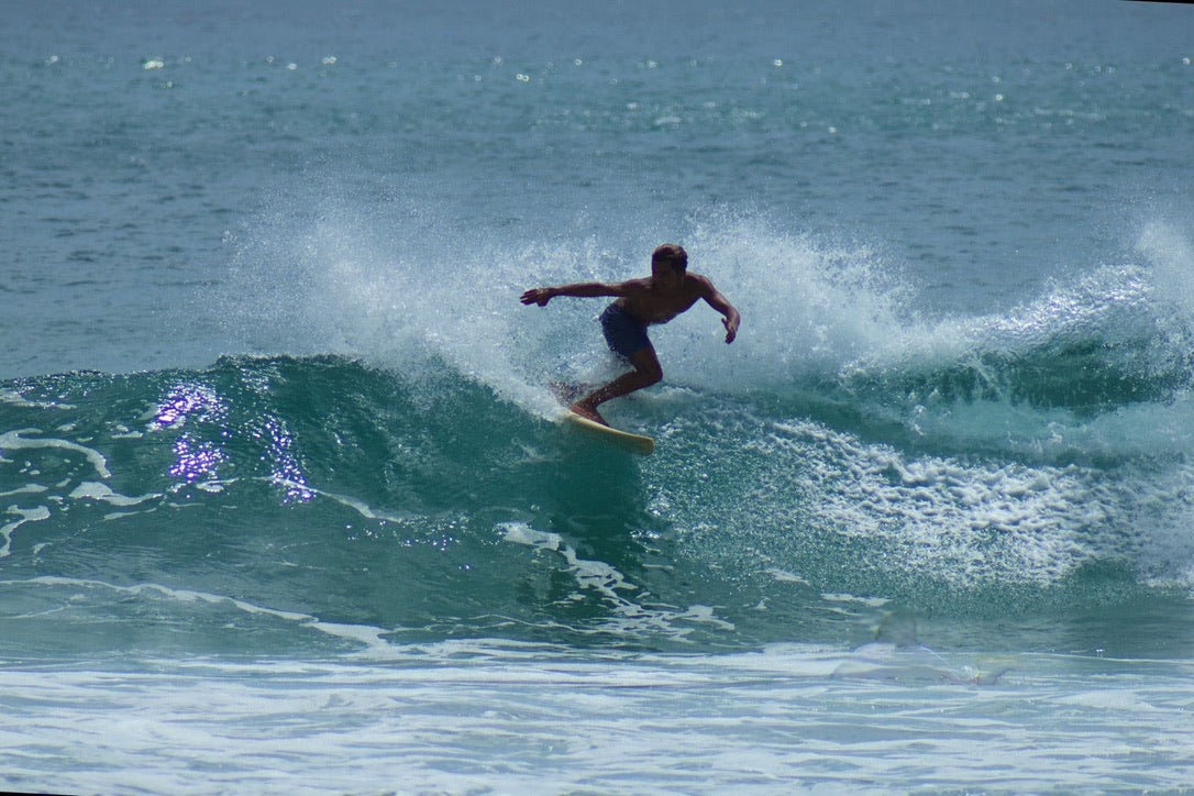 Surfer riding a Pacific wave during a Nicaragua surf experience